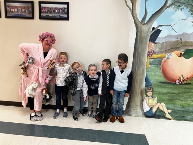 Students with a staff member dressed up as someone who is 100 years old. 